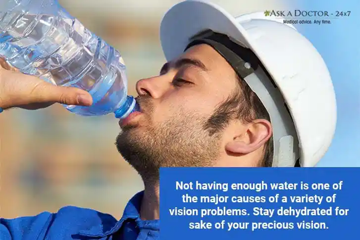 man drinking water from a plastic bottle=